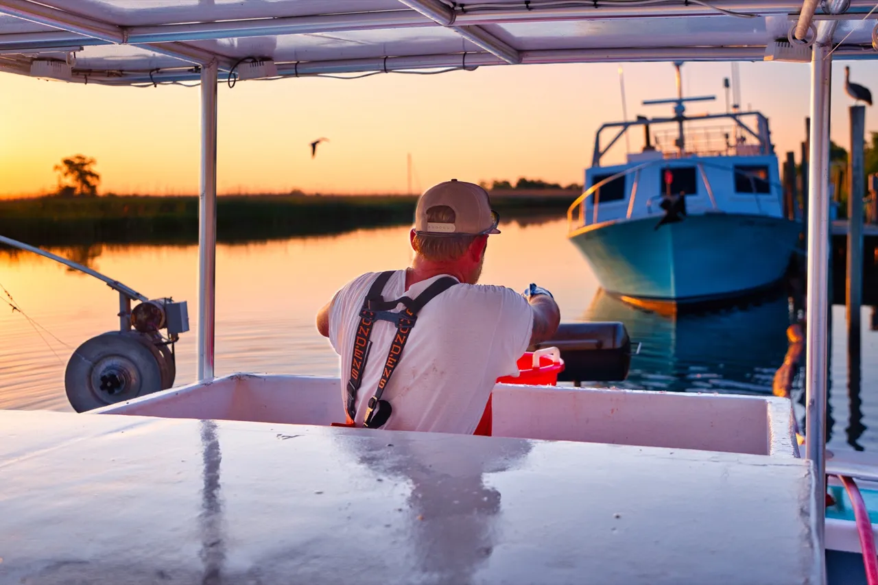 A Water Street crew member at work on the boat at sunrise