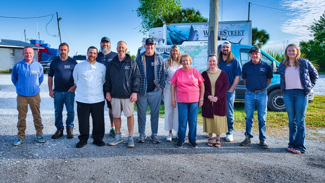 Water Street employees standing together beside a refrigerated delivery truck